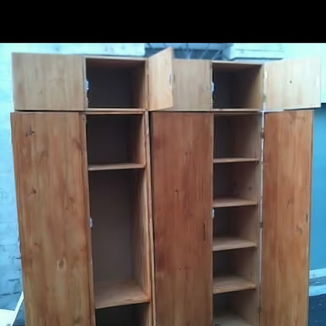 Une grande armoire de rangement en bois (ou vestiaire / étagère à casiers) avec plusieurs portes ouvertes révélant des niches de rangement.